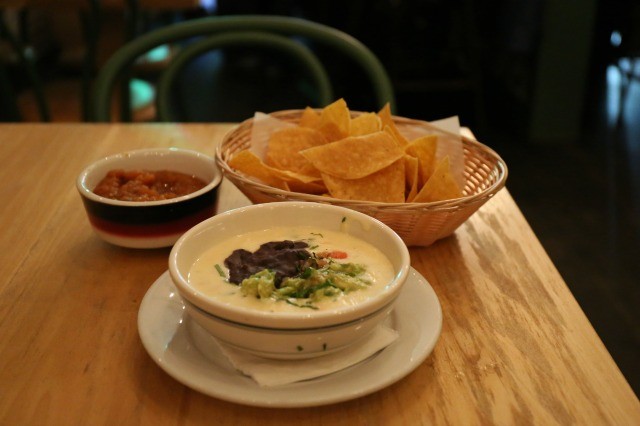 White Mag Mud Queso dip with guacamole, chips and beans at Javelina restaurant.