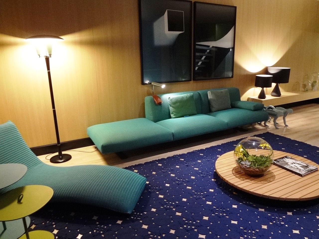 Living room with teal couches and a blue carpet