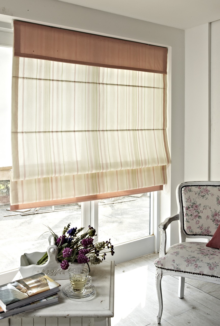 Beige fabric curtains hung in a white-colored living room