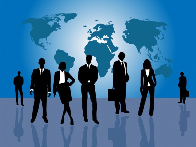 businesspeople dressed in black and white with the world map as the background