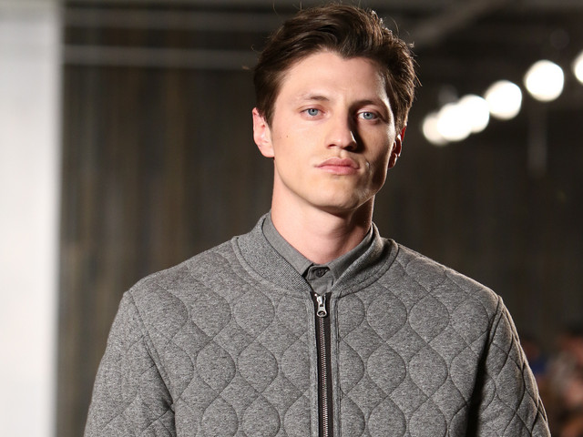 Male model wearing bomber jacket on runway in Spring 2016 NYC fashion show