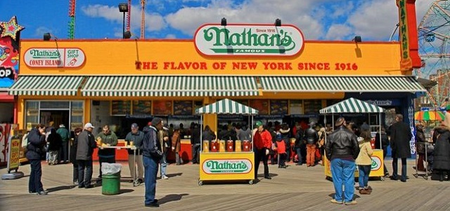 Nathan's Famous storefront on the boardwalk in Coney Island on a sunny day