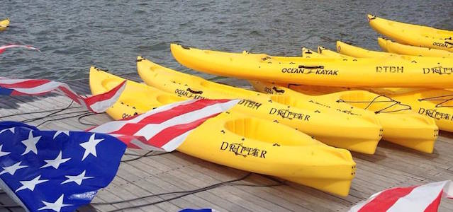 A row of docked bright yellow Ocean Kayaks at Downtown Boathouse in New York City.