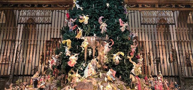 The Christmas tree at the MET with angels and figurines placed on it for decoration.