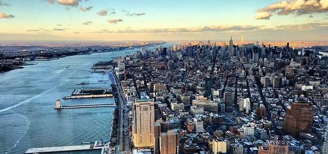 A clear day overlooking New York City and the Hudson River from a skyscraper.