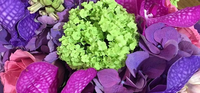 Pink, purple, and bright green flowers in an arrangement.