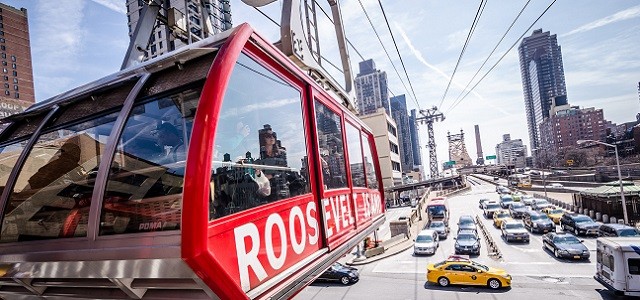 A tram over New York City headed to Roosevelt Island on a sunny day.