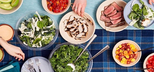 A table top spread of salad and salad toppings at Chopt salad bar in New York City.