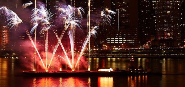 A barge with fireworks sails down the Hudson River celebrating the 4th of July in NYC.