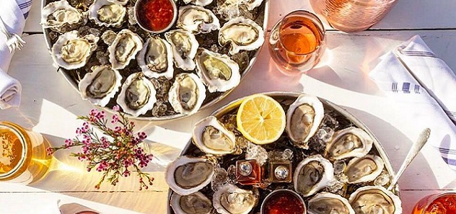 A spread of fresh oysters and seafood dishes at Grand Banks in NYC.
