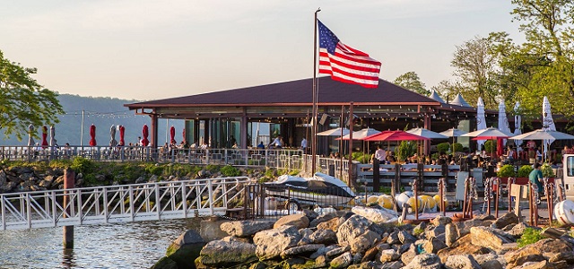 An exterior view of La Marina in NYC at sunset and their outdoor seating area.