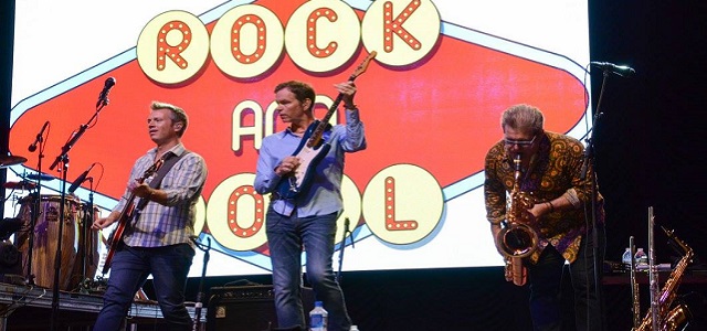 A group of musicians on stage at SummerStage playing guitar.