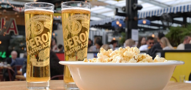 Two glasses of Peroni and a bowl of popcorn at the Eataly outdoor movie event.