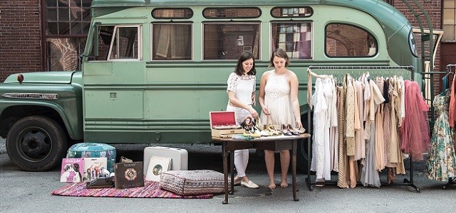 Two women at an outdoor antique fair.