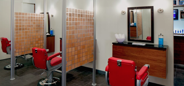 An interior view of Truman's barber shop with red leather chairs in NYC.