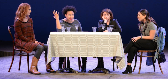A group of women sitting at a table as actors at a comedy show in New York City.