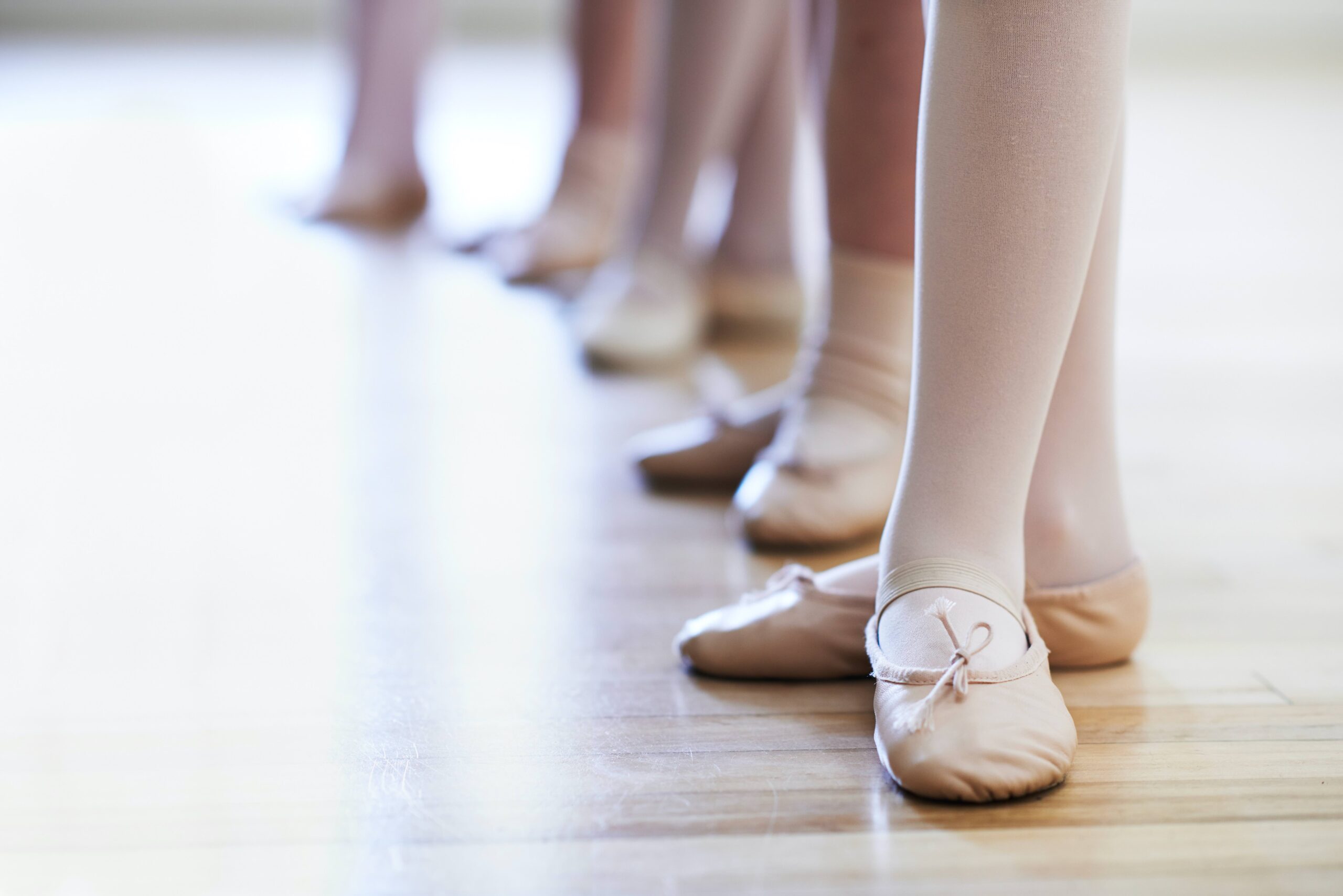 A close up of ballet shoes in a ballet class