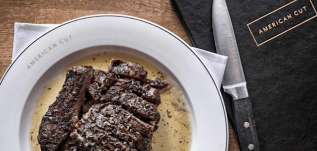 A freshly cooked steak and knife at American Cut in NYC.