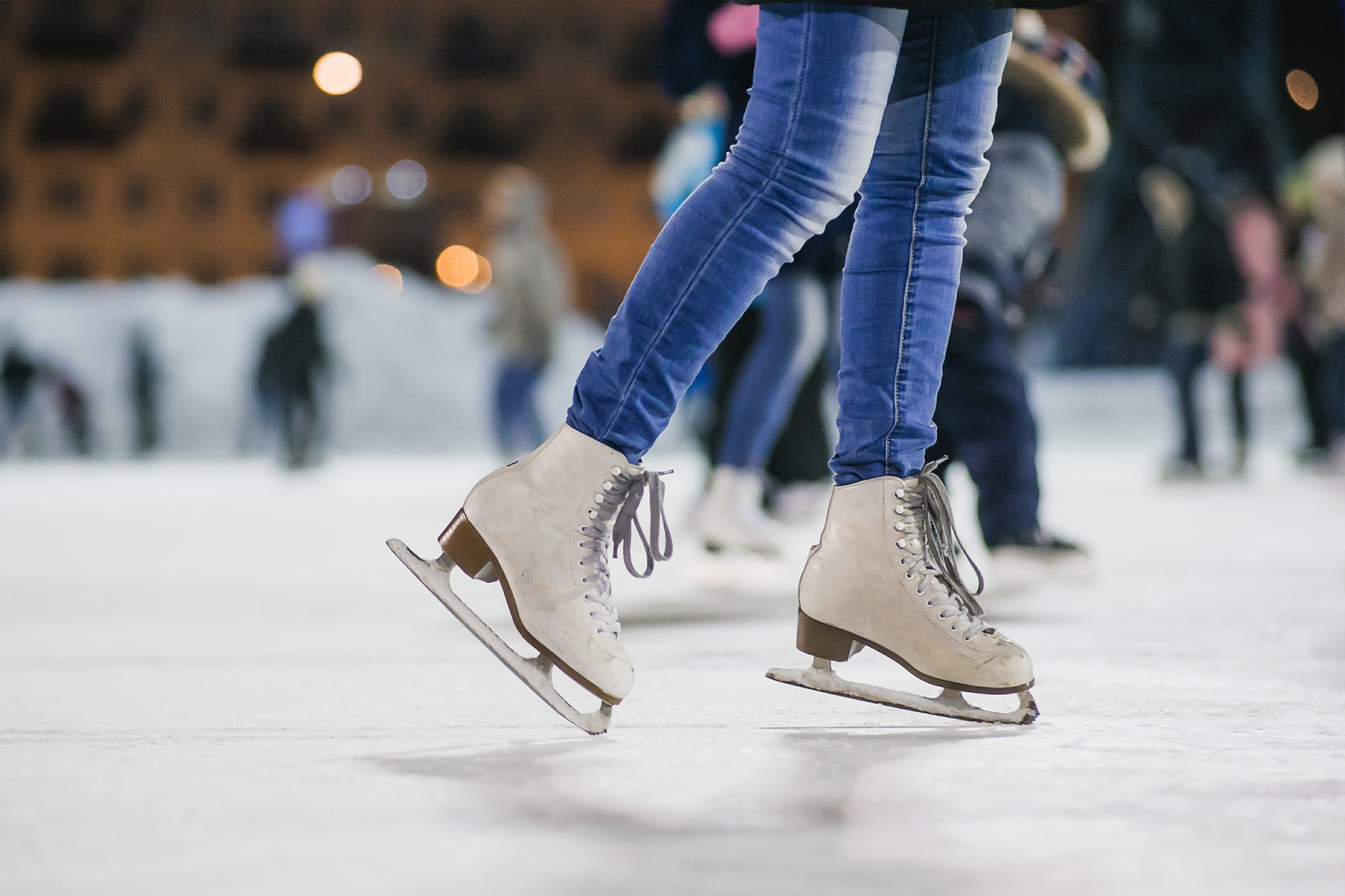 Girl skating on ice shot of her jeans and ice skates