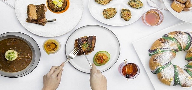 A dining table at Cafe Boulud with fresh food plates.