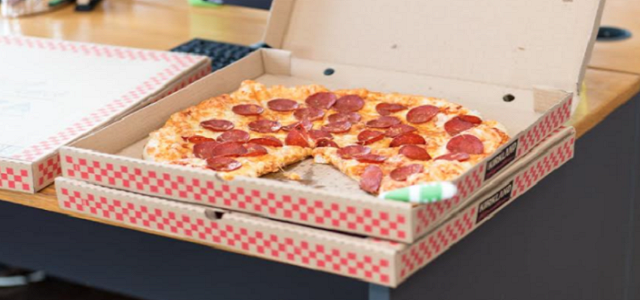 A stack of fresh and hot delivered pizzas.