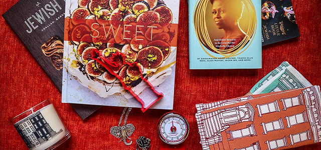 A table with brightly colored ethnic cookbooks.