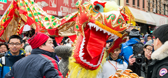 A crowd gathered around a colorful Chinese dragon.