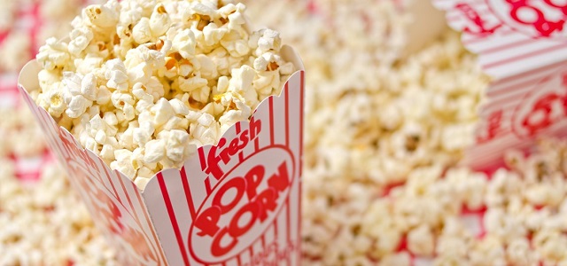 Two red and white striped boxes of fresh popcorn.
