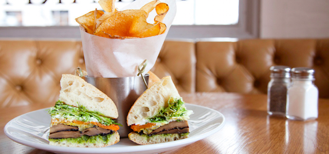 A freshly made sandwich on a wooden booth table at Sarabeth's restaurant in NYC.