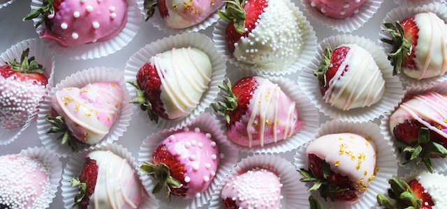A dozen strawberries covered in white and strawberry chocolate themed for Valentine's Day.
