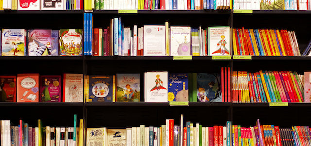 A bookcase with many shelves filled with colorful children's books.