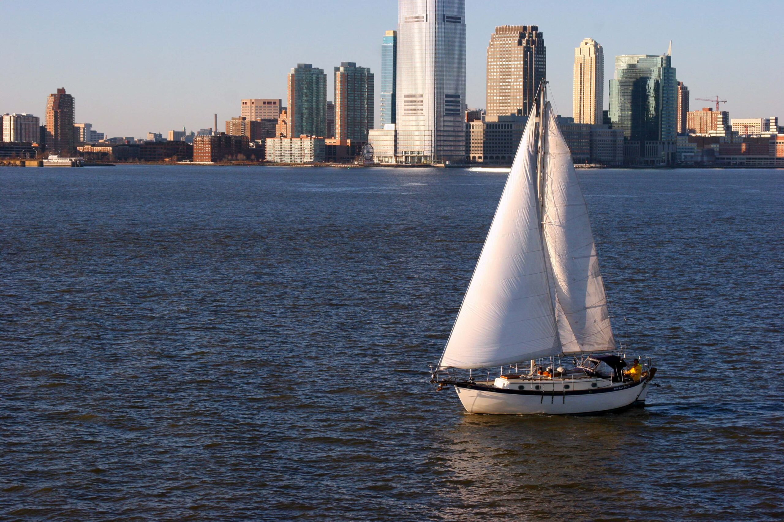 A boat in the Hudson River and buildings of New York City in the USA during daytime