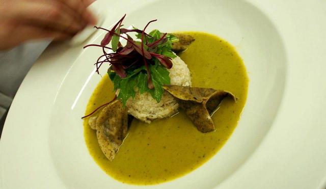 A bowl of pea soup with garnish