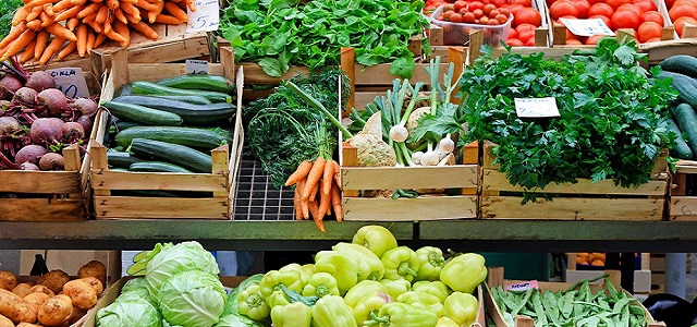A collection of fresh produce and vegetables at a farmers market in NYC.