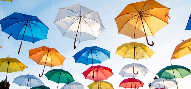 A collection of hanging colorful umbrellas.