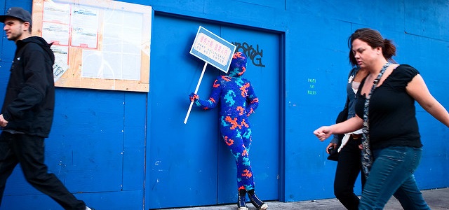 colorful person holding sign