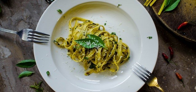 green pasta with cheese and parsley