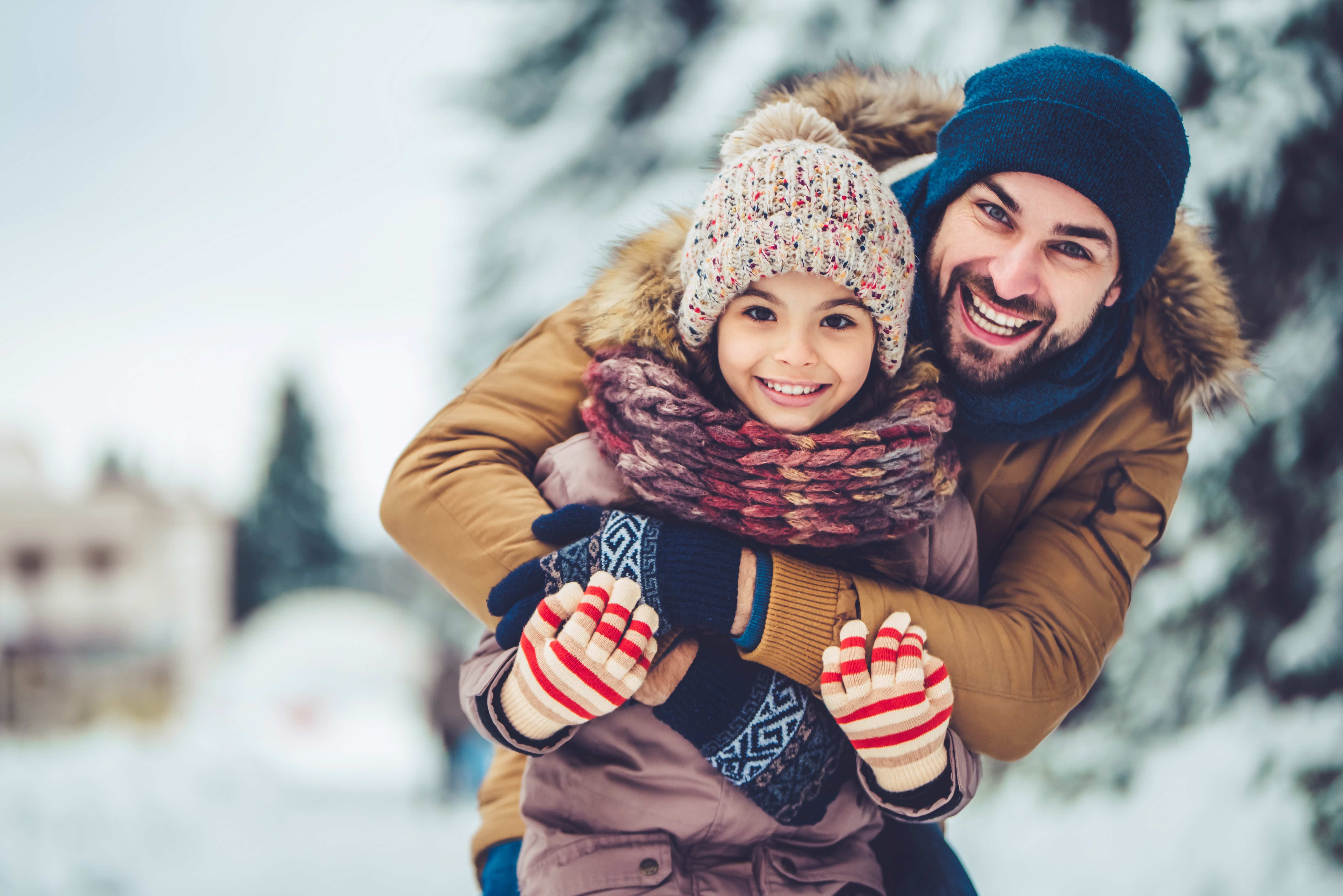 Dad with daughter outdoor in winter snow