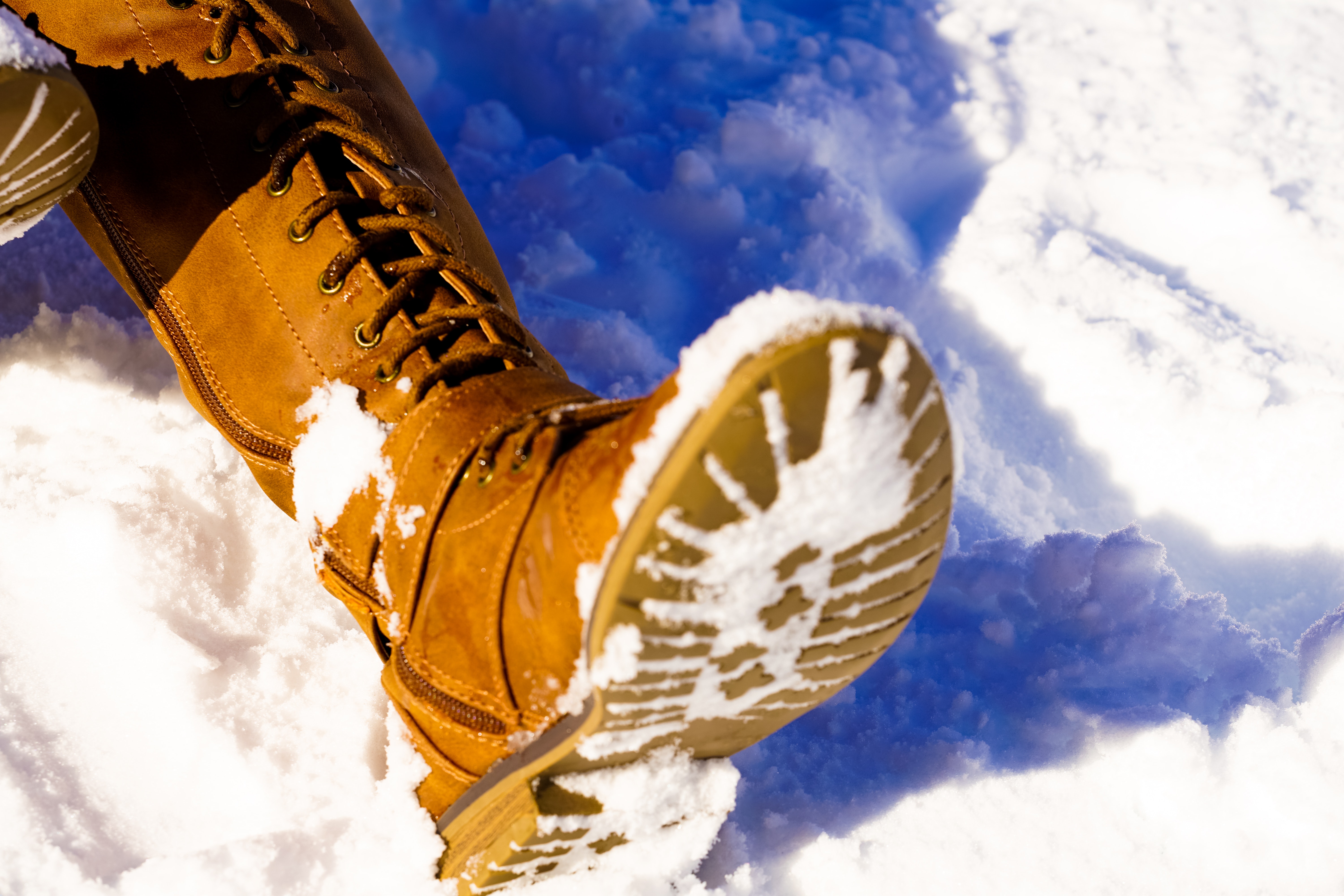 Brown snow boots stepping in snow