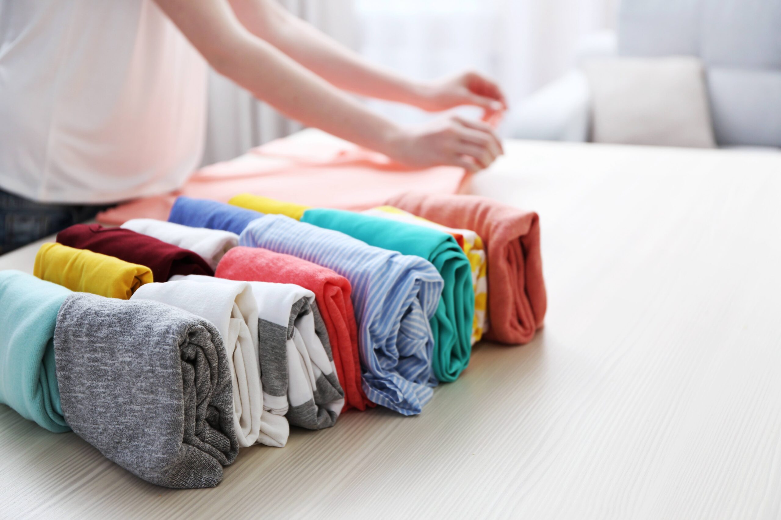 person folding laundry