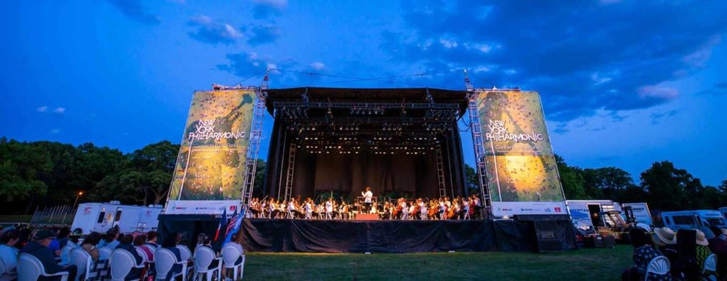 concert in the park, people standing in park