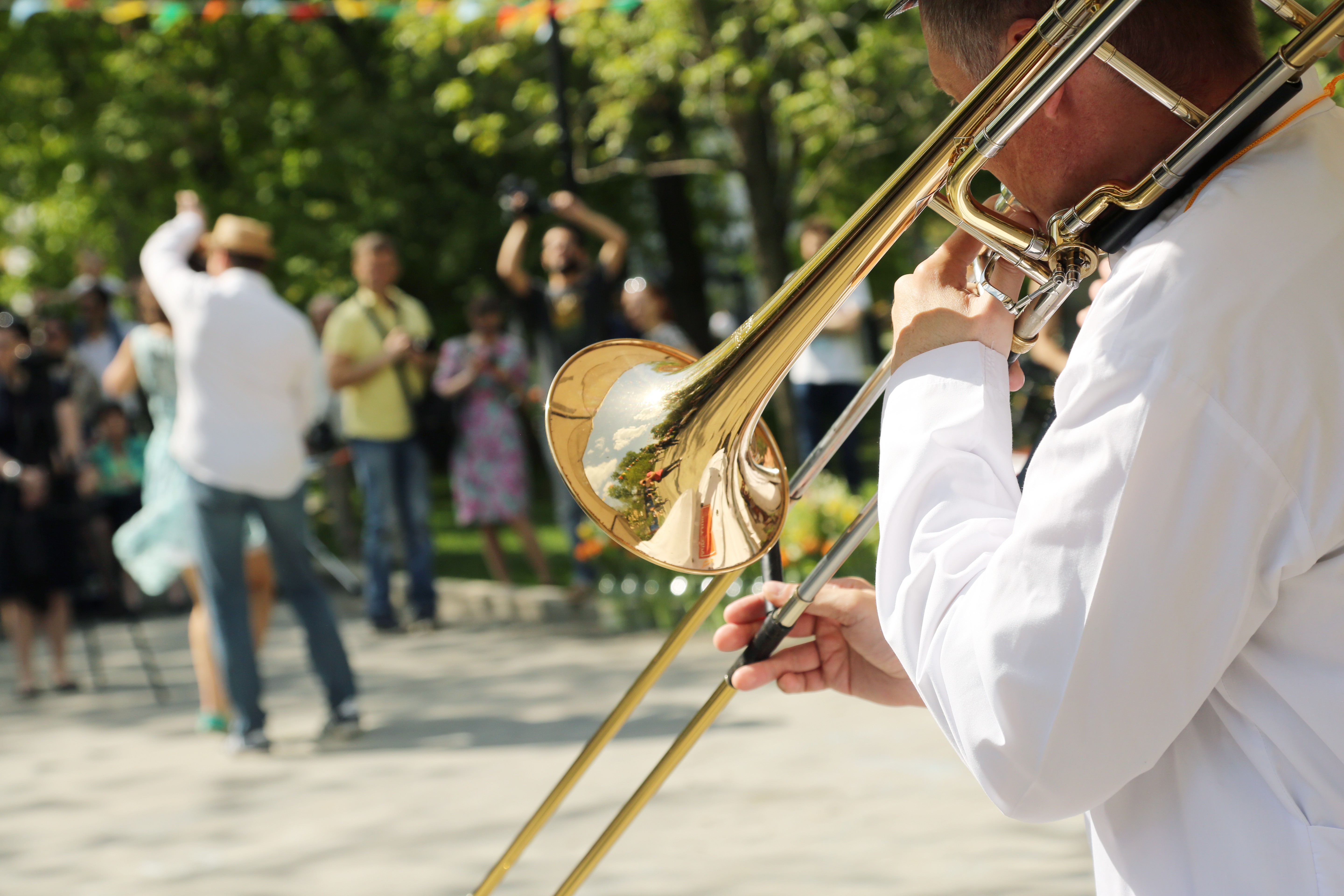 man playing trumpet in park