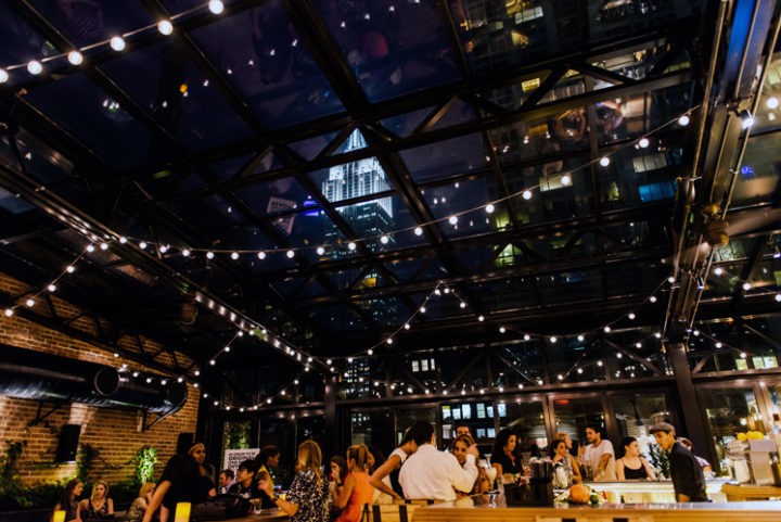 people enjoying drink on rooftop bar