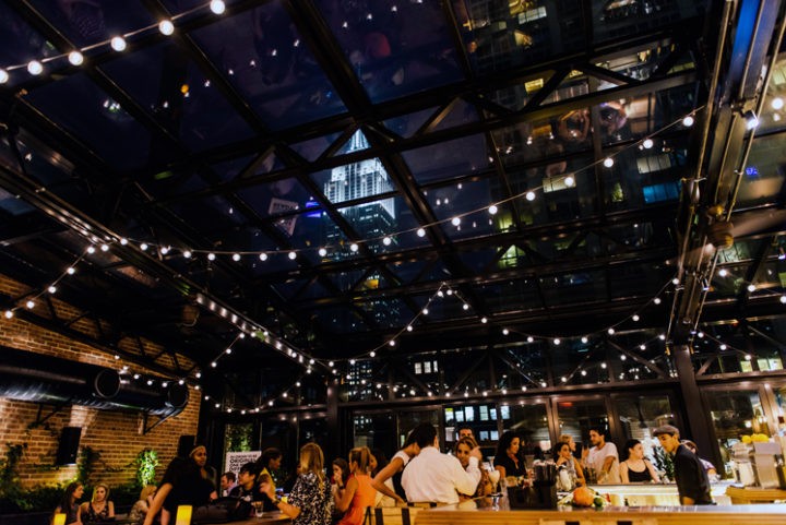 people enjoying drink on rooftop bar