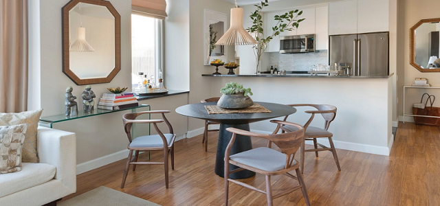An interior view of a Glenwood apartment kitchen and dining space with bright windows and upgraded amenities.
