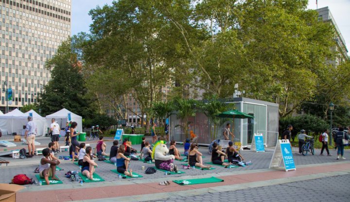 People doing yoga on nyc streets with no cars