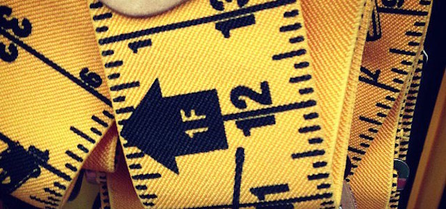 A bright yellow tape measure for a tenant toolbox in your apartment.