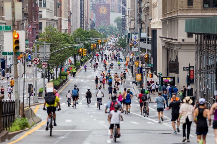 People biking and running in nyc streets with no cars