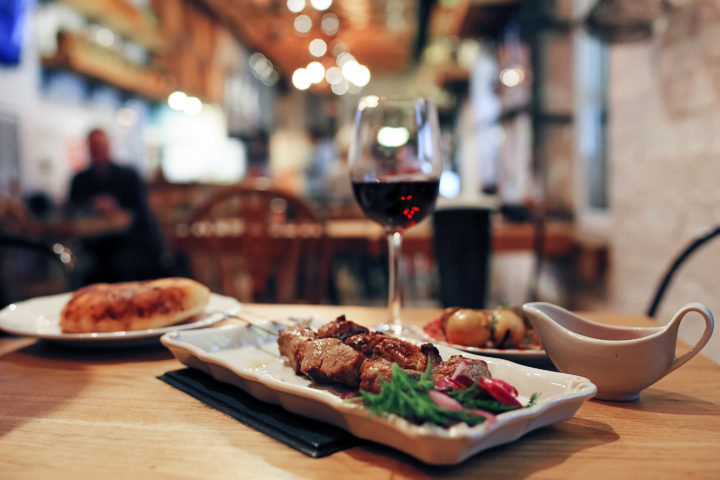 Dinner dish and wine served in a rustic wooden restaurant 