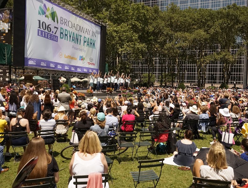 People waiting on the lawn at Bryant Park for the musical to start. 